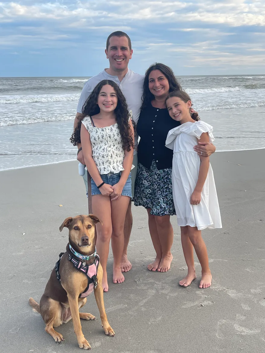 Nick Bochette with his family and dog on the beach